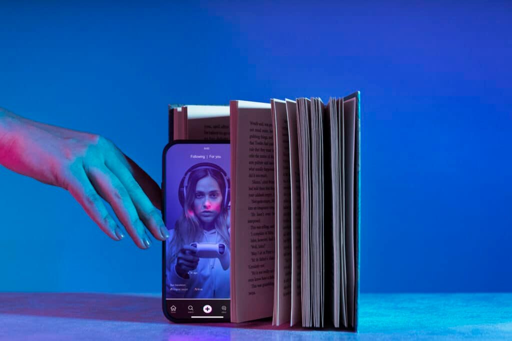 Still life of books vs technology representing digital content vs traditional content marketing strategies